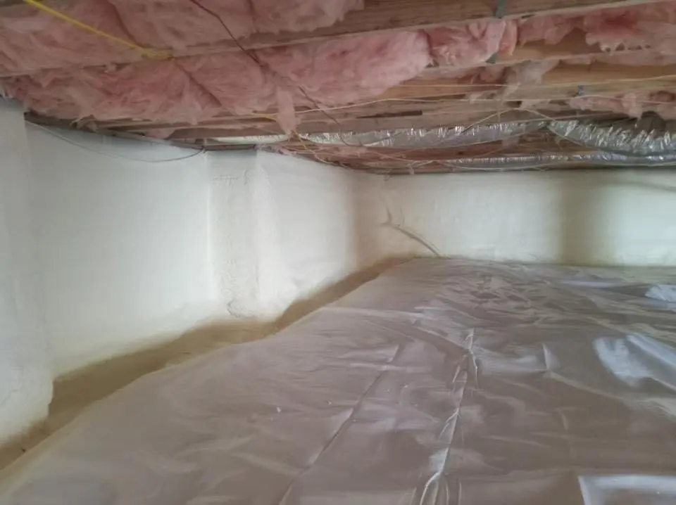 Crawl space encapsulation with closed-cell spray foam for Commercial Roof Restoration in Massena